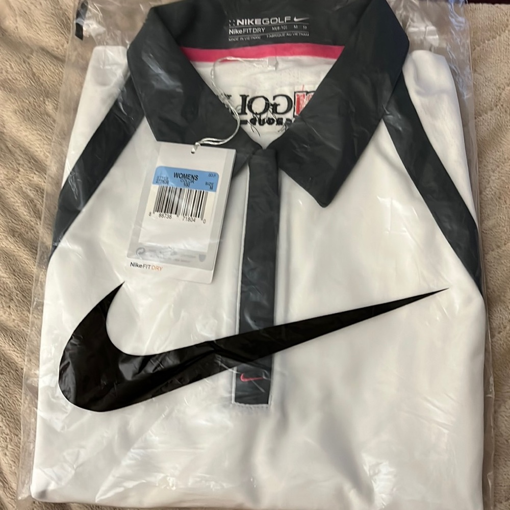Womens Nike golf shirt. New with tags. White with black accents. Size medium.